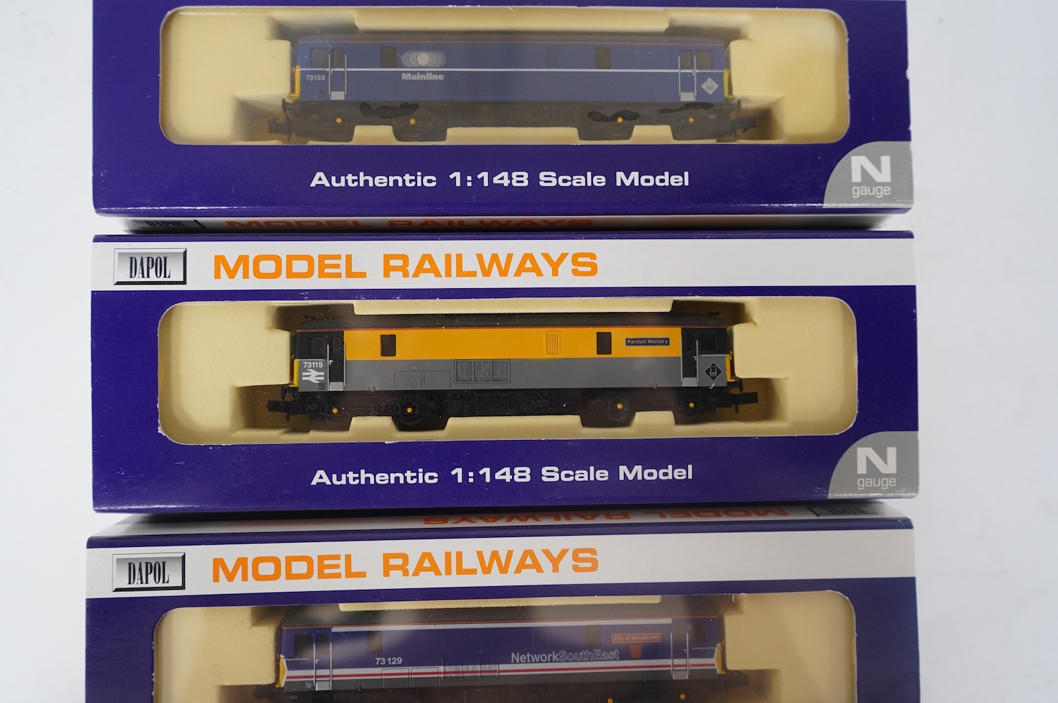 Three boxed Dapol N gauge railway Class 73 electro-diesel locomotives; 73119 Kentish Mercury (ND-022a), 73129 City of Winchester (ND-012a) and 73133 (ND-021b). Condition - good.